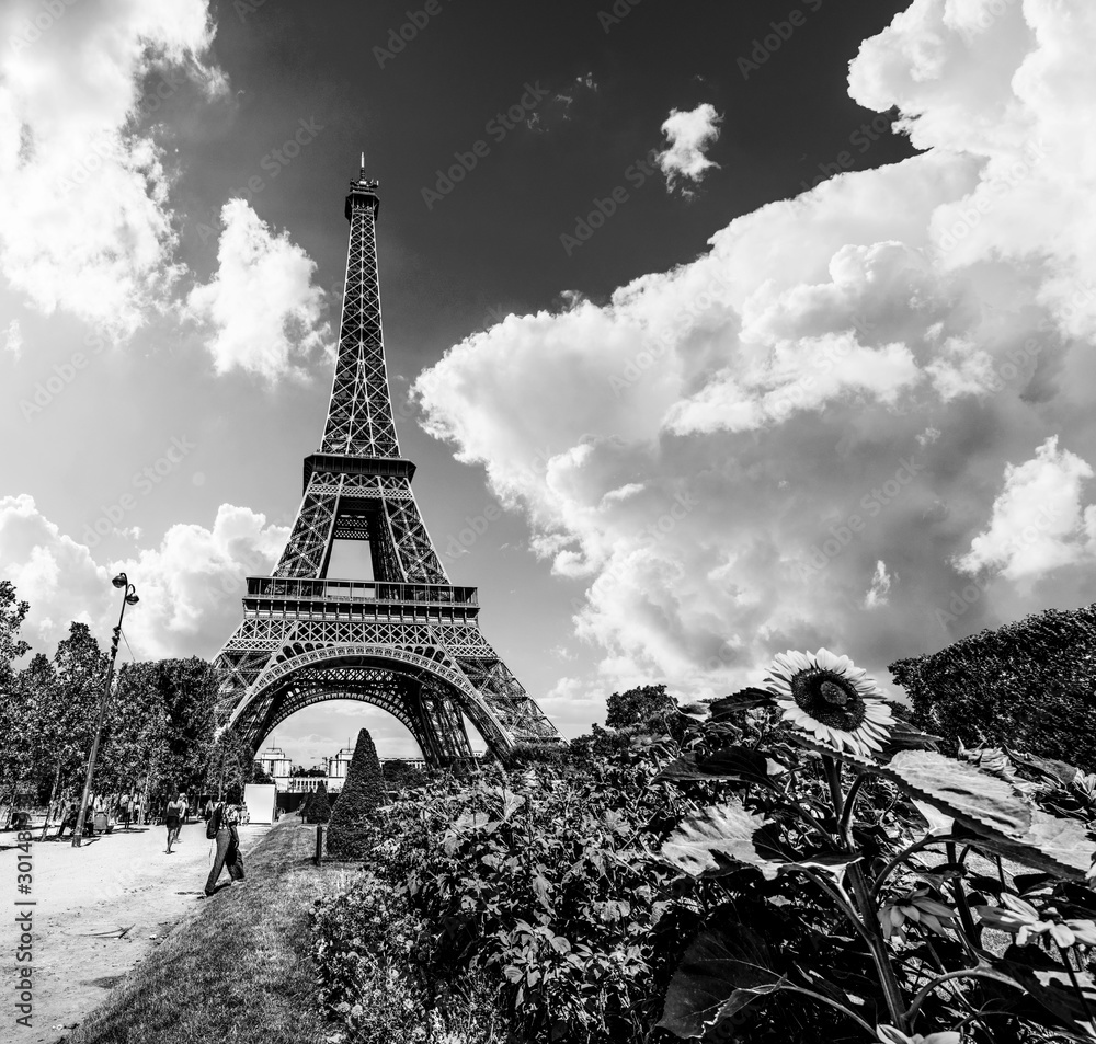 Tourists by world famous Eiffel tower in Paris in black and white