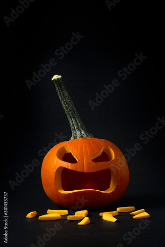 Conceptual vertical photo of carved pumpkin to represent tooth loss.