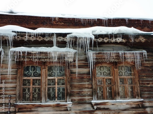 Old Russian house with icicles on the Windows