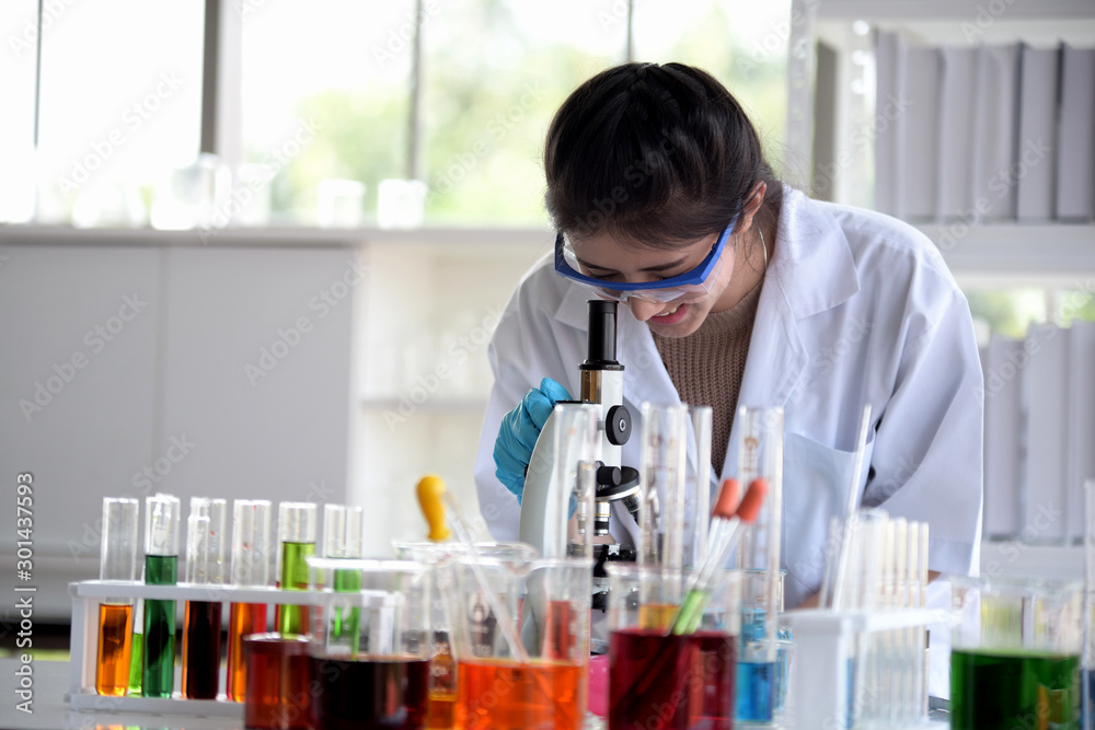 Young women scientists are experimenting with science at the lab Young women scientists are experimenting with science at the lab