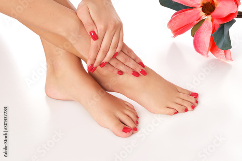 Beautiful red manicure and pedicure isolated on white background. © forma82