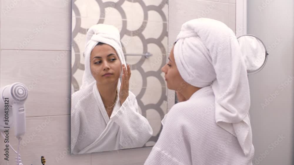 Happy woman looking at her skin Happy woman looking at her skin