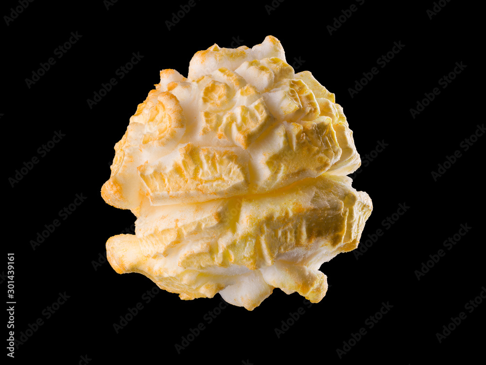 Single popped popcorn on a black background. Close-up or macro with clipping path Single popped popcorn on a black background. Close-up or macro with clipping path