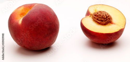 Peaches, Whole and half with stone against white