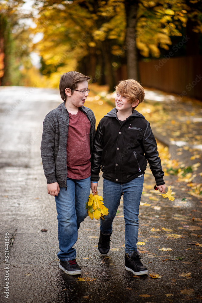 young boys walking in autumn park young boys walking in autumn park