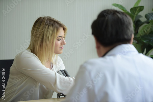 Beautiful girl consulted the doctor,Woman talking to doctor psychiatrist in hospital,Discuss issue and find solutions to mental health problems.