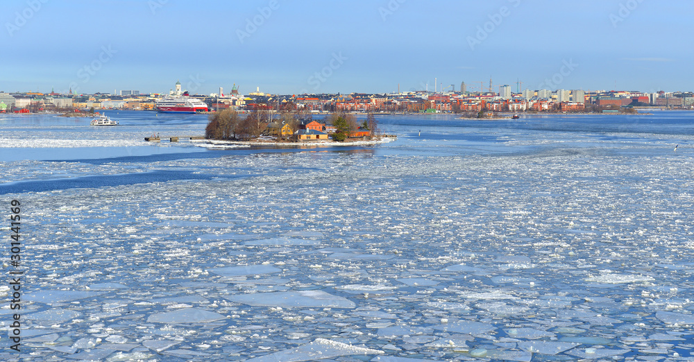 Spring and ice in Baltic Sea against background of Helsinki. Finland