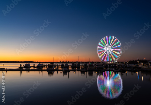 Illuminated ferris wheel at National Harbor near the nation capital of Washington DC at sunset