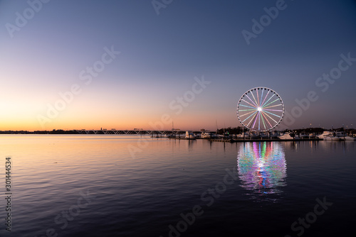 Illuminated ferris wheel at National Harbor near the nation capital of Washington DC at sunset