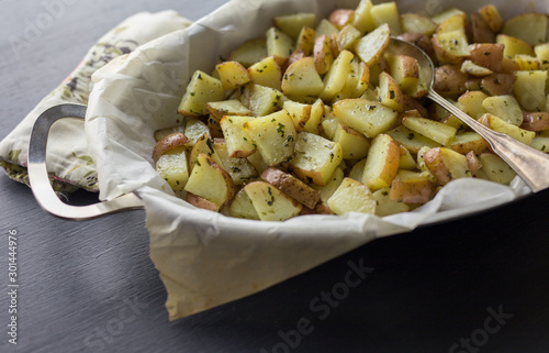 Cubed potatoes with herbs roasted in parchment paper. 