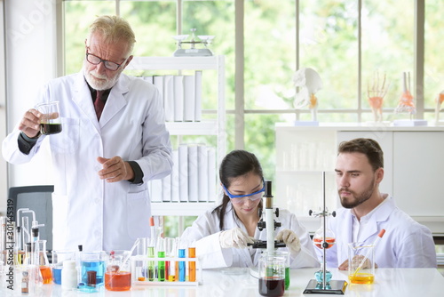 Scientists are working in science labs.Close-up of a scientistYoung female scientist looking through a microscope in a laboratory doing research photo