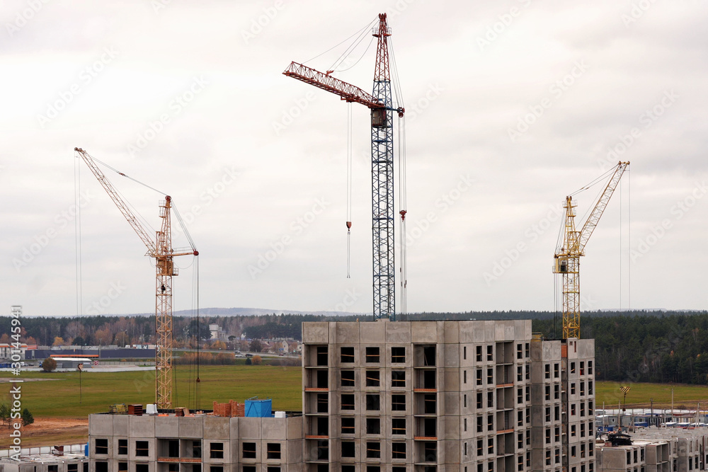 construction of a new residential quarter. cranes over multi-storey buildings under construction