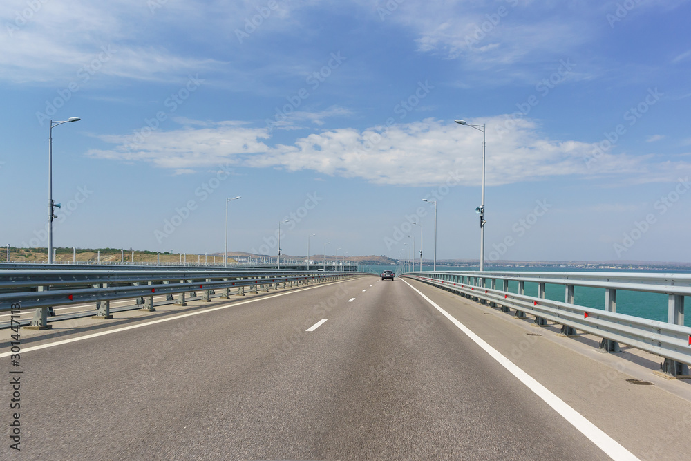Crimean bridge across the Kerch Strait. Descent from the height of the navigable arch span. Ahead Of Kerch. Sunny day