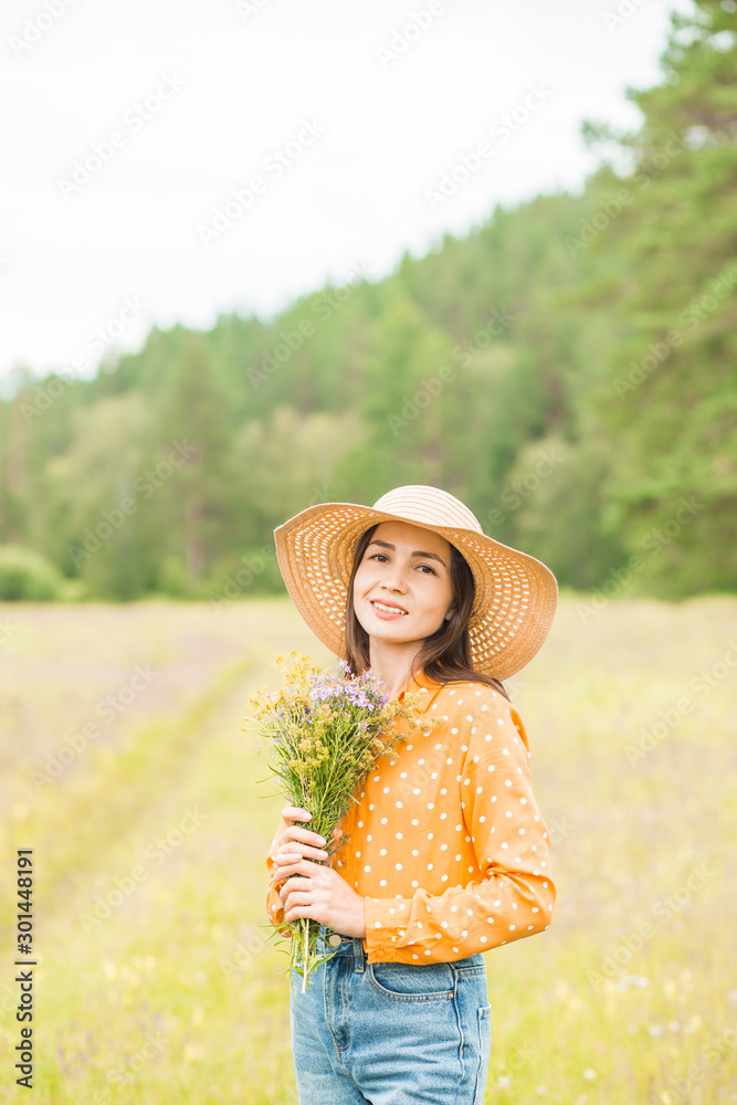 Portrait of young beautiful woman on green background summer nature.