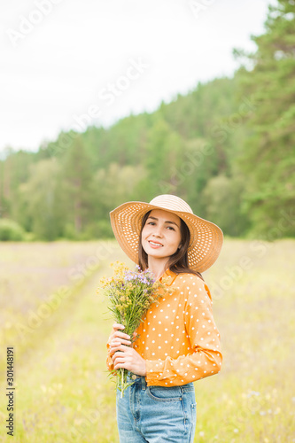 Portrait of young beautiful woman on green background summer nature.
