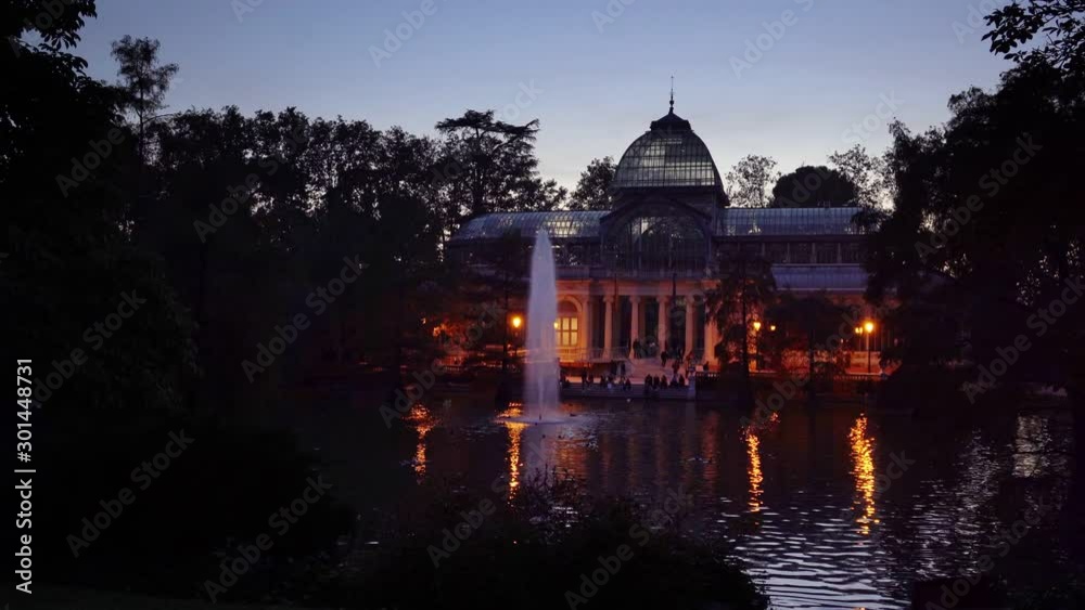 Sunset view of Crystal Palace or Palacio de cristal in Retiro Park in Madrid, Spain. The Buen Retiro Park is one of the largest parks of the city of Madrid, Spain