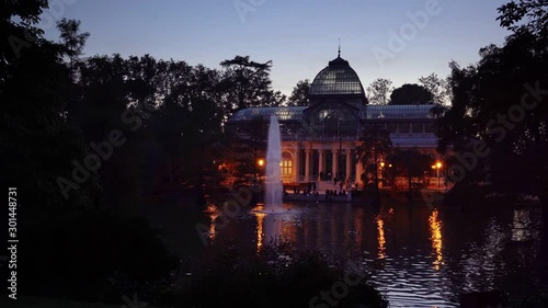 Sunset view of Crystal Palace or Palacio de cristal in Retiro Park in Madrid, Spain. The Buen Retiro Park is one of the largest parks of the city of Madrid, Spain