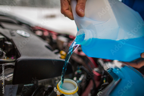 Pouring antifreeze liquid, Antifreeze screen wash photo