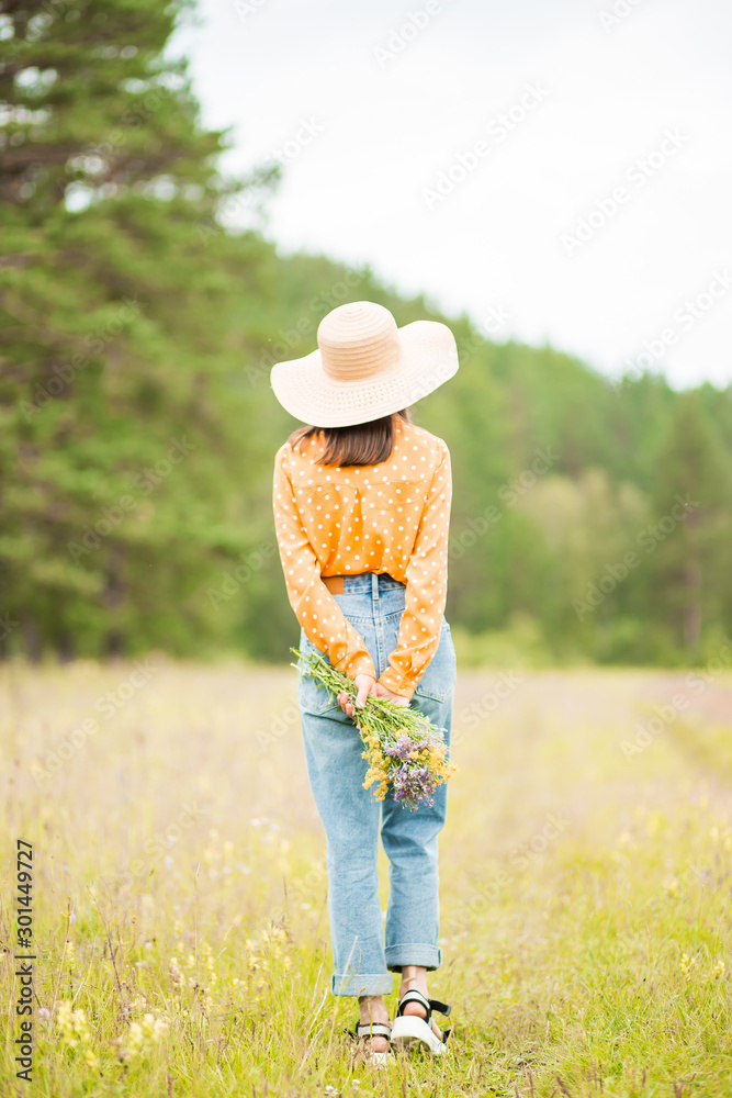 Portrait of young beautiful woman on green background summer nature.