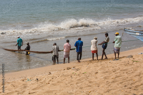 Galle, Sri Lanka fishermen pull a fishing net on the beach 16 November 2018 in Galle, Sri Lanka