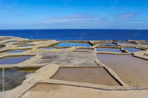 Obraz na płótnie Salt evaporation ponds or salterns or salt pans near Qbajjar of Gozo, Marsalforn, Malta w salonie
