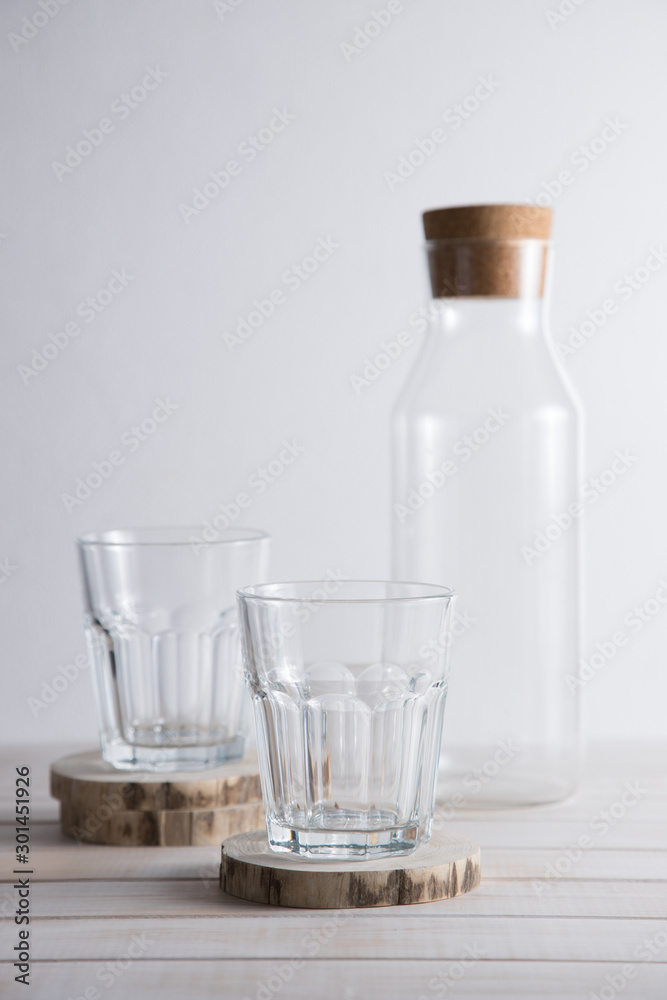 Glasses and carafe for drinks on a light background. Glasses and carafe for drinks on a light background.