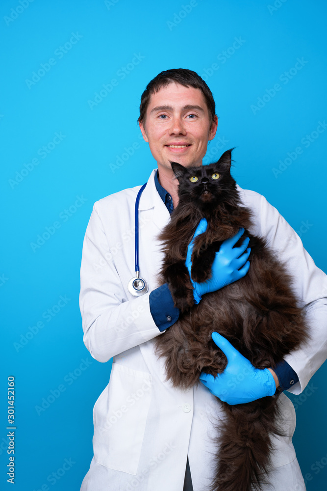 Vet with black cat in his arms nd Vet with black cat in his arms nd