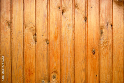 Background of wooden boards painted with stain in yellow.