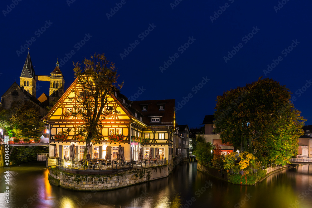 Germany, Beautiful night view over old town of medieval city esslingen am neckar reflecting in silent neckar river water by night