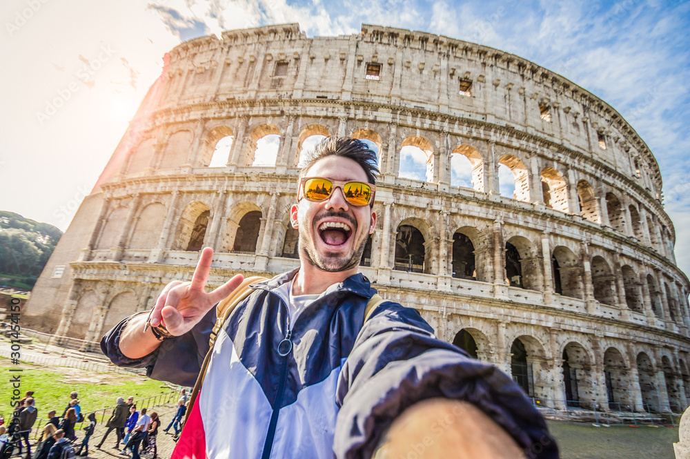 Happy tourist taking a selfie at the Colosseum in Rome