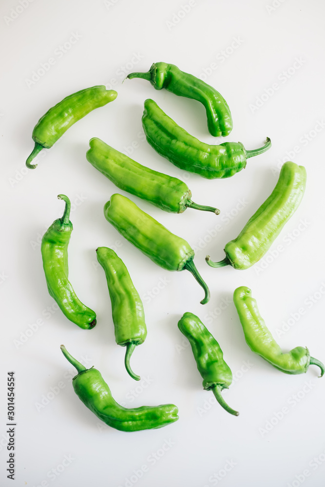 Green peppers isolated on white background. Top view