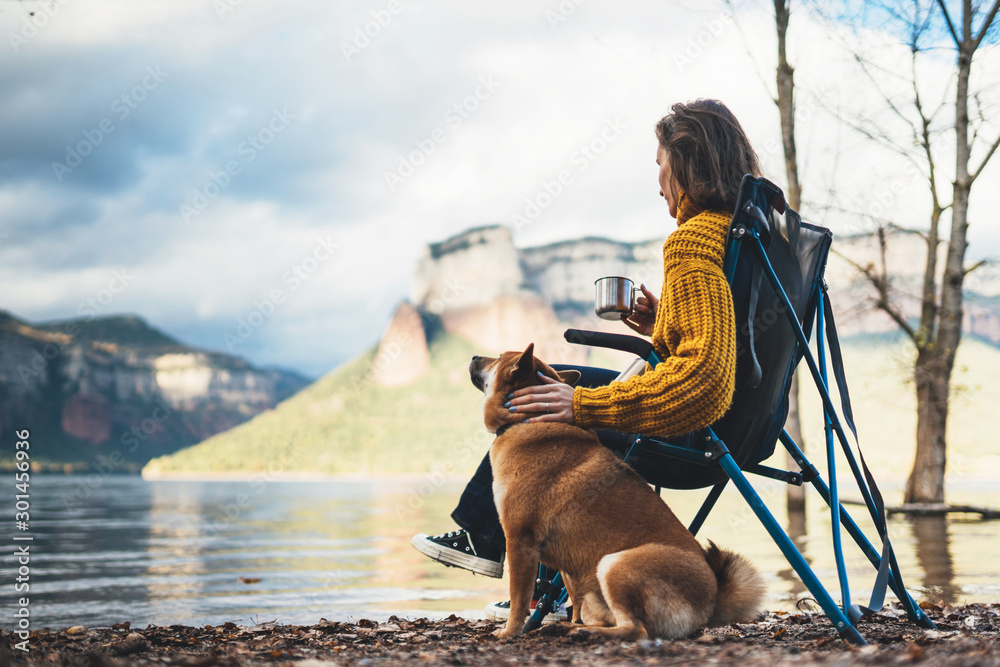 tourist traveler girl rest together dog on background mountain, woman drink  tea hugging puppy pet on lake shore nature trip, friendship love concept  Stock Photo | Adobe Stock