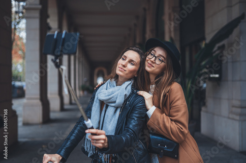 Girlfriends tourist taking photo self portrait together on smartphone mobile. Blogger travels in europe city. Vacation holiday friendship concept. Travelers self cellphone technology mockup