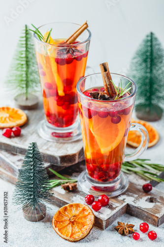Orange and cranberry drinks with orange slices and spices. Hot drinks for winter and Christmas