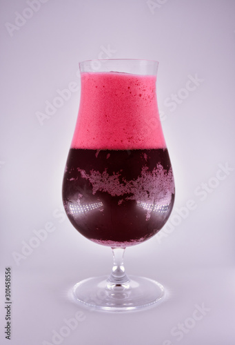 glass on a white background, a glass with cherry beer photo