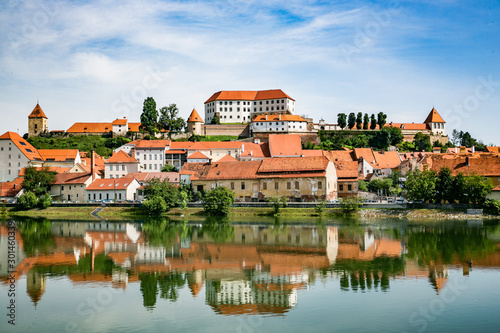 Ptuj town in Slovenia - oldest city in Slovenia. Panoramic view over Old Town and castle with a reflection in Drava River.