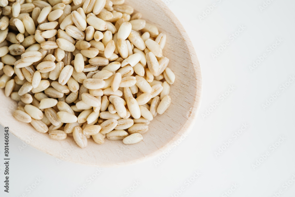 Wheat grain in wooden spoon