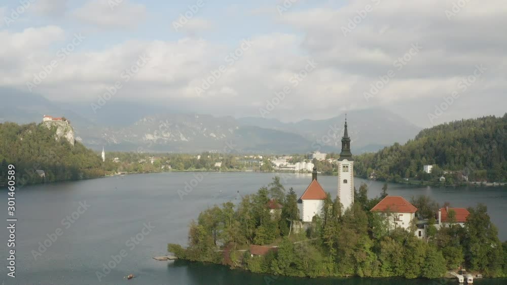 Aerial panoramic view of Lake Bled with famous Bled Island and Bled Castle in the background in scenic morning light Aerial panoramic view of Lake Bled with famous Bled Island and Bled Castle in the background in scenic morning light