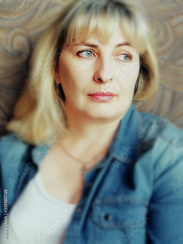 Portrait of a beautiful blonde girl in a denim shirt.