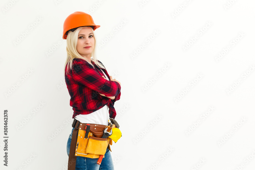 Attractive blonde business woman working as an architect on a building construction site