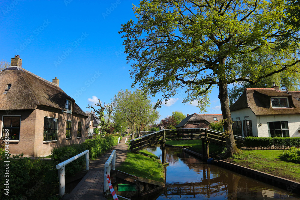 Bridge over the canal in venice of the north - small cosy village Giethoorn in Netherlands