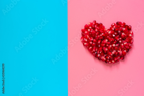 ripe and delicious pomegranate on blue and pink