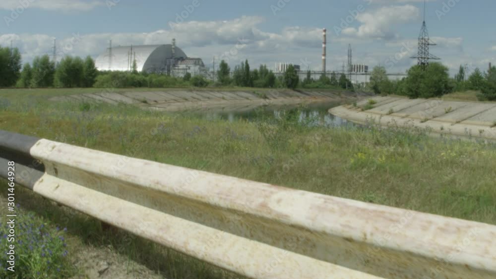 Chernobyl Nuclear Reactor. Wide Shot Reveal Tracking from Behind Guard Rail to Reveal Reactor in Chernobyl, Ukraine Chernobyl Nuclear Reactor. Wide Shot Reveal Tracking from Behind Guard Rail to Reveal Reactor in Chernobyl, Ukraine