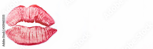 Imprint or print of red lipstick on a white background, isolate. Make-up female lips close-up, banner. Concept of love, makeup and beauty. Sexy red lips on white, kiss.