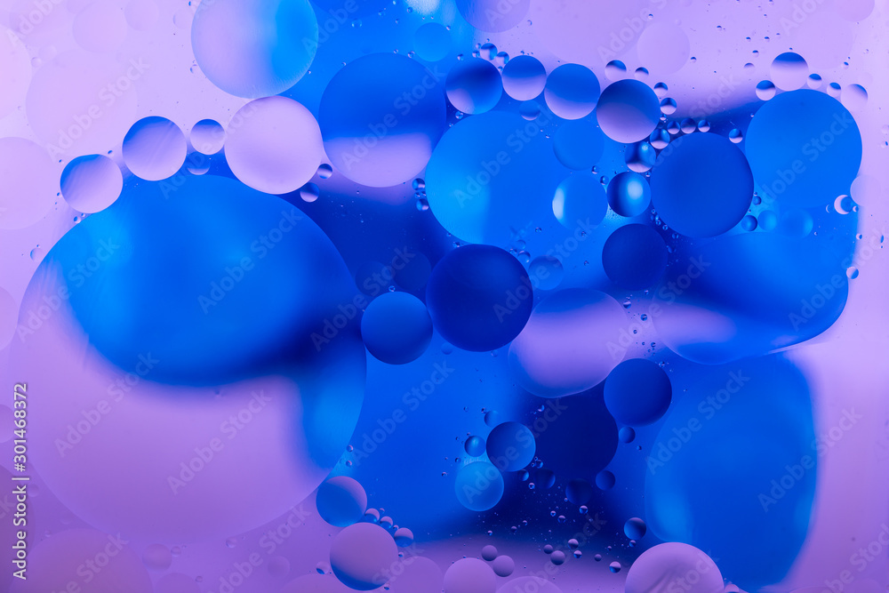 bright oily drops in water with colorful background, close-up bright oily drops in water with colorful background, close-up