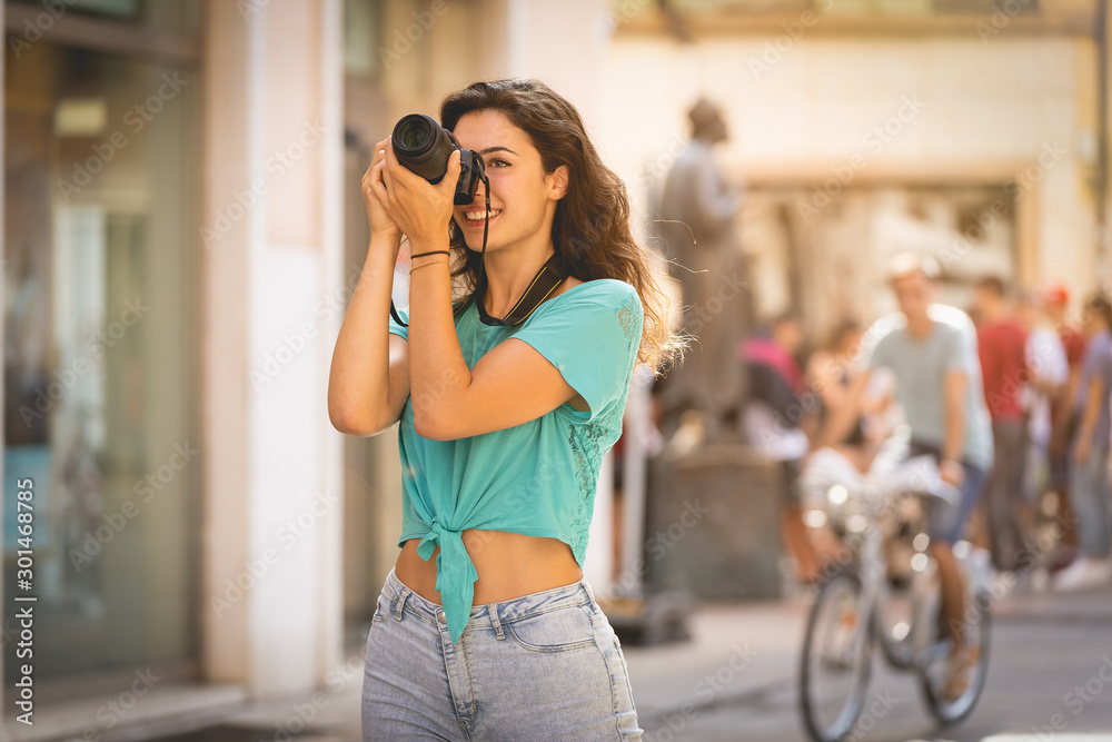 Girl tourist or professional photographer who shoots in a typical Italian city, Europa, Verona