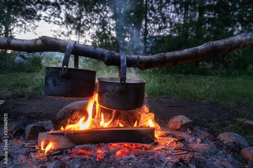 Cooking dinner at the campfire. Camping food. photo