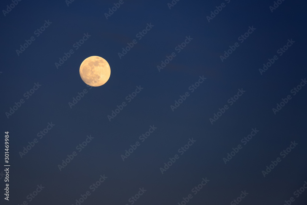Picturesque full moon against a blue sky. Full planet moon with craters, text space. Night landscape for weather forecast Picturesque full moon against a blue sky. Full planet moon with craters, text space. Night landscape for weather forecast