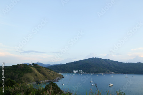 Blue sea landscape with mountains and sailing ships. photo