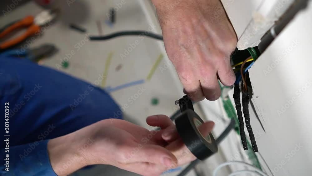 Electrician insulates wires with tape Electrician insulates wires with tape